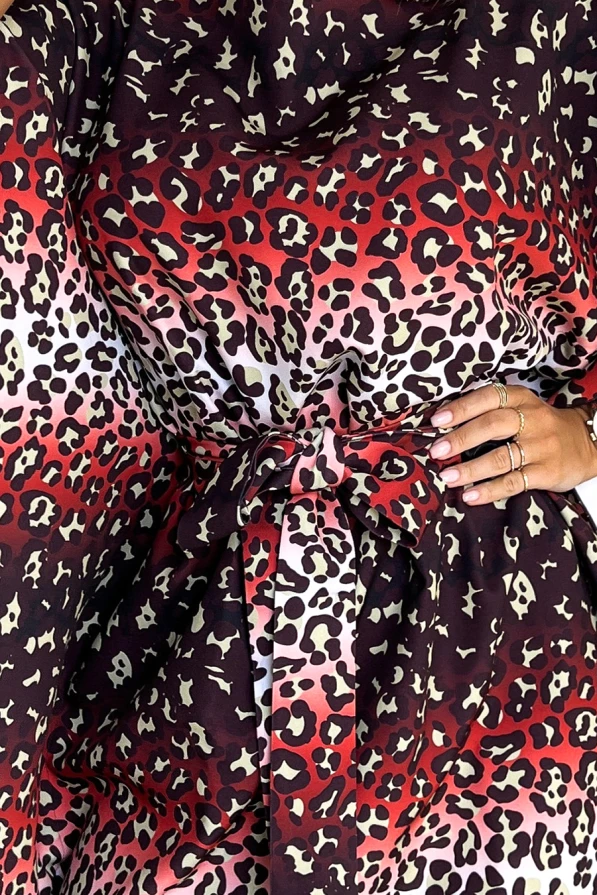 Elegantiška suknelė su ryškiu leopardiniu raštu, pereinančiu nuo tamsiai rudos iki šviesiai rožinės spalvos. Suknelė turi plačią juostą, kuri pabrėžia liemenį.