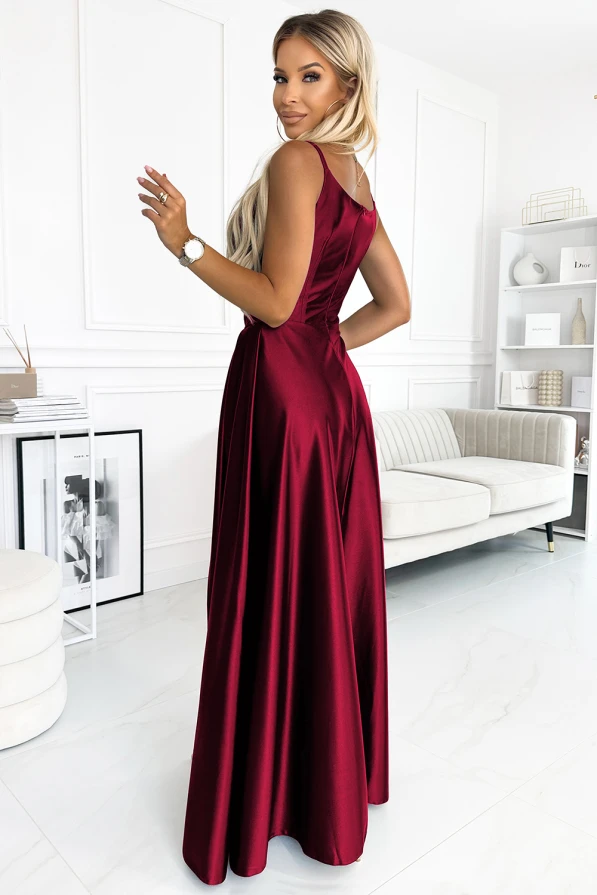 Elegantiška ilga raudona suknelė su plonomis petnešėlėmis, puikiai tinkanti ypatingoms progoms. Suknelė pasižymi prabangiu blizgesiu ir elegantišku siluetu, kuris pabrėžia figūrą.