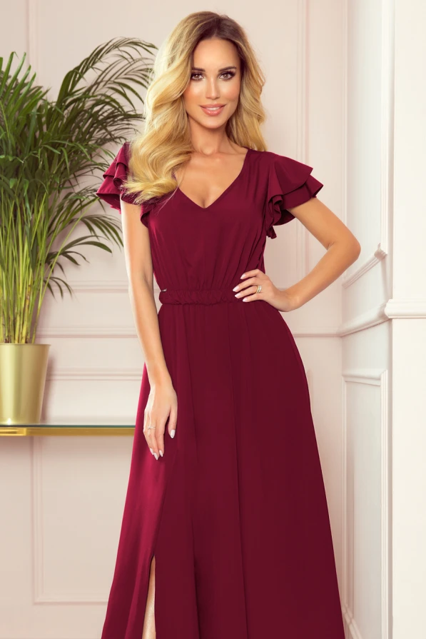Ilga bordo spalvos suknelė su V formos iškirpte ir trumpomis rauktomis rankovėmis suteikia elegancijos ir rafinuotumo. Suknelė turi subtilų skeltuką, kuris prideda žavesio ir moteriškumo.