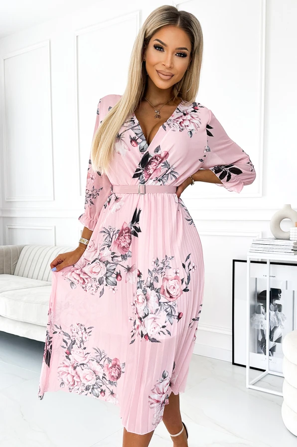 Rožinė plisuota suknelė su gėlių raštais suteikia elegancijos ir moteriškumo. Suknelė turi V formos iškirptę ir trijų ketvirčių rankoves, puikiai tinkančias įvairioms progoms.