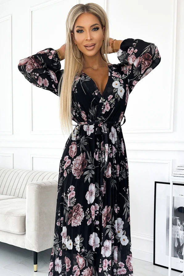 Elegantiška, juoda midi suknelė su gėlių raštu ir plisuota sijono dalimi suteikia rafinuotumo ir moteriškumo. Suknelė turi ilgas rankoves ir V formos iškirptę, pabrėžiančią figūrą.