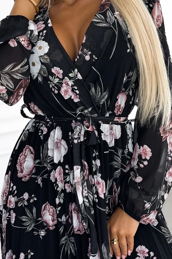 Elegantiška juoda midi suknelė su gėlių raštais ir plisuota apačia suteikia rafinuotumo ir moteriškumo. Suknelė turi ilgomis rankovėmis ir dirželiu, kuris pabrėžia liemenį.